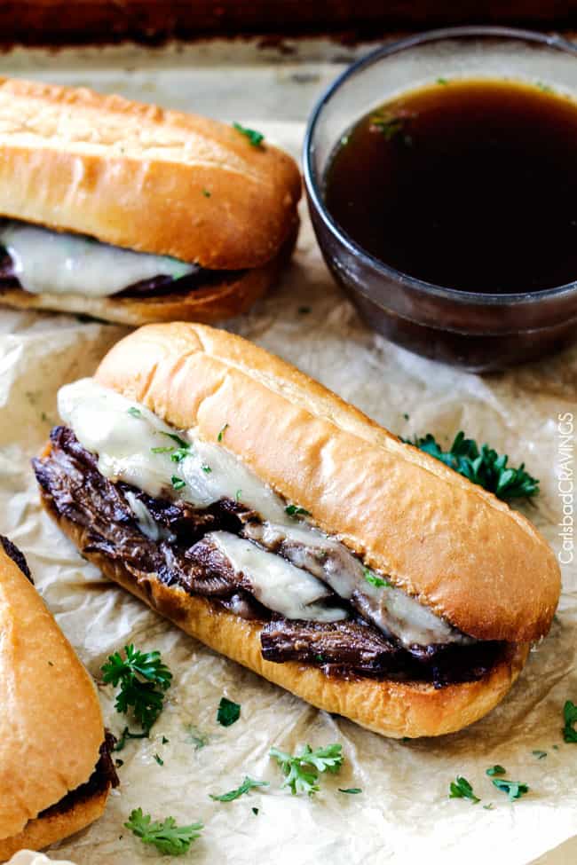 5 minute prep Crazy tender Slow Cooker French Dip Sandwiches seeping with spices are unbelievably delicious and make the easiest dinner or party food. You haven't had French Dip Sandwiches until you try these! 