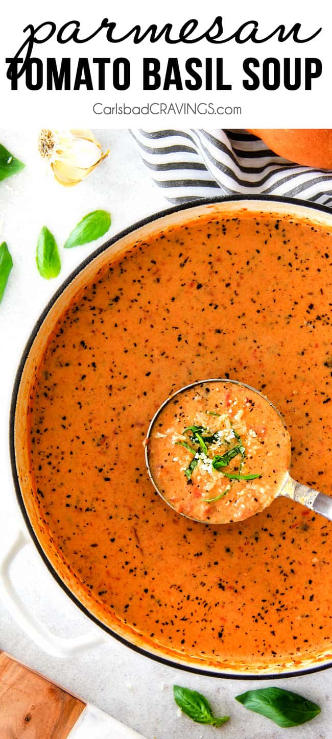 top view of Tomato Basil Soup recipe in a white pot with a ladle full of soup