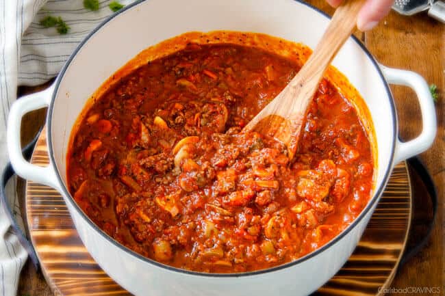 Mixing the sauce for Cheesy Tortellini being served with a spoon.