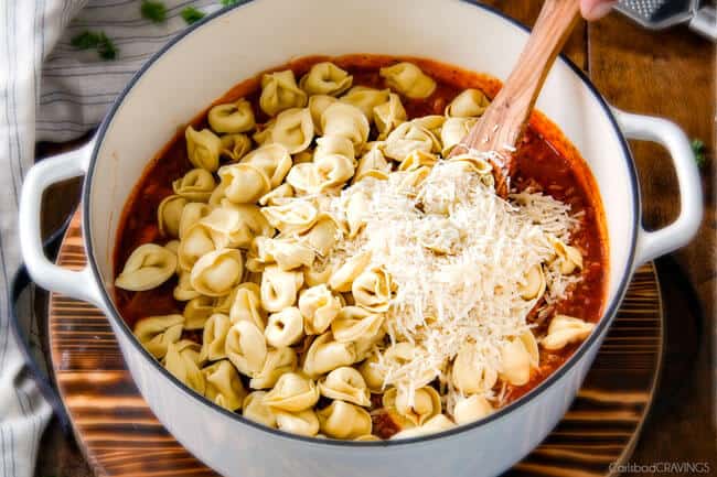 Showing how to make Cheesy Tortellini by dding tortellini and cheese.