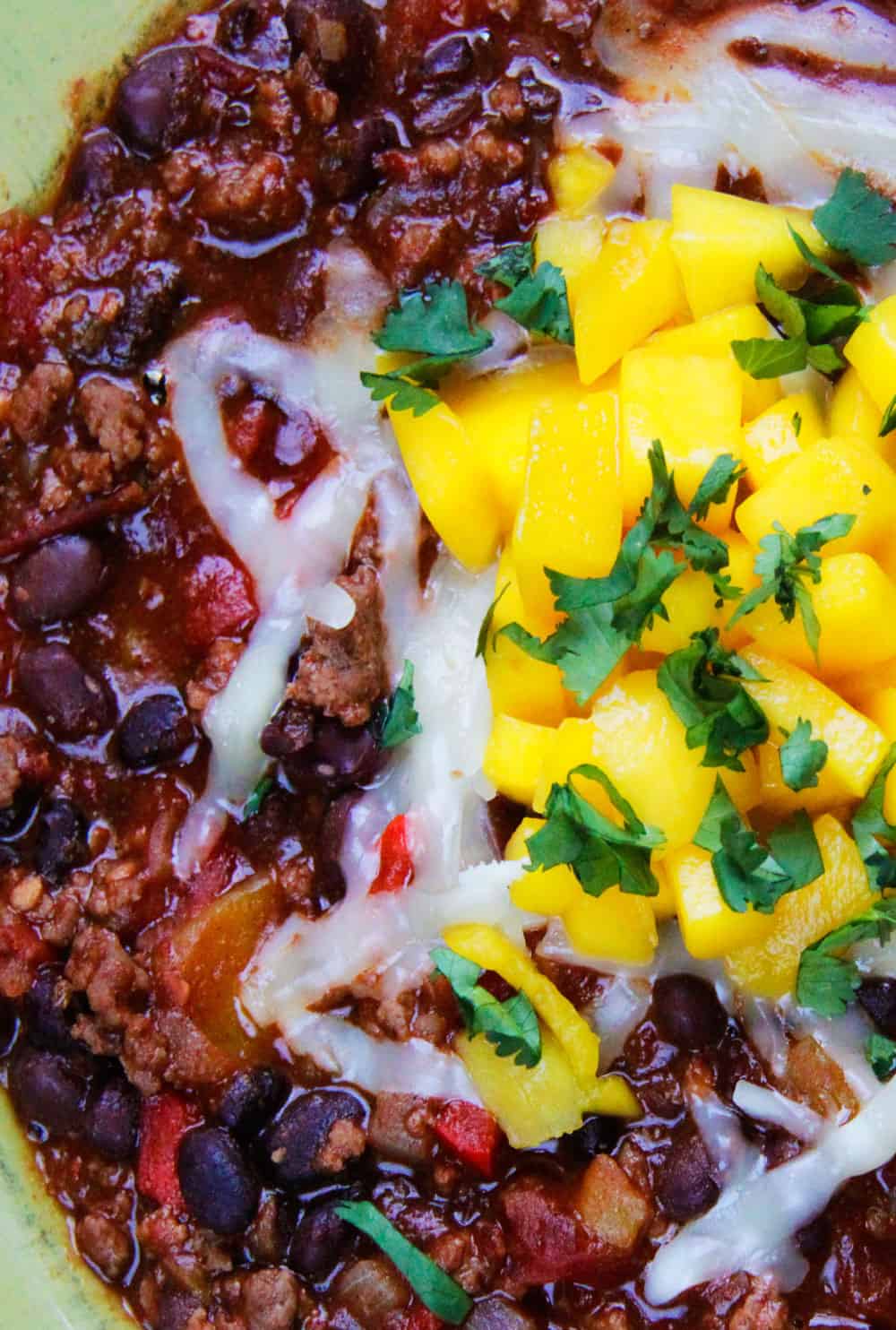 Close up of Mango Black Bean Chili in a green bowl.