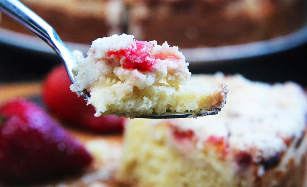 a bite on a fork of strawberry coffee cake with cream cheese