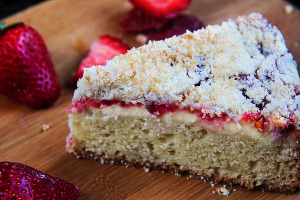A slice of sour cream coffee cake with strawberries