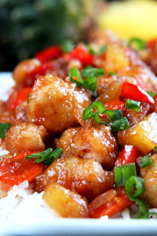 The BEST Sweet and Sour chicken - takeout OR homemade - I have ever had in my entire life! It is also baked with pineapple, carrots, onions and bell peppers all in ONE BAKING DISH! No need to stir fry extra veggies! #sweetsourchicken #chinesefood #fakeouttakeout