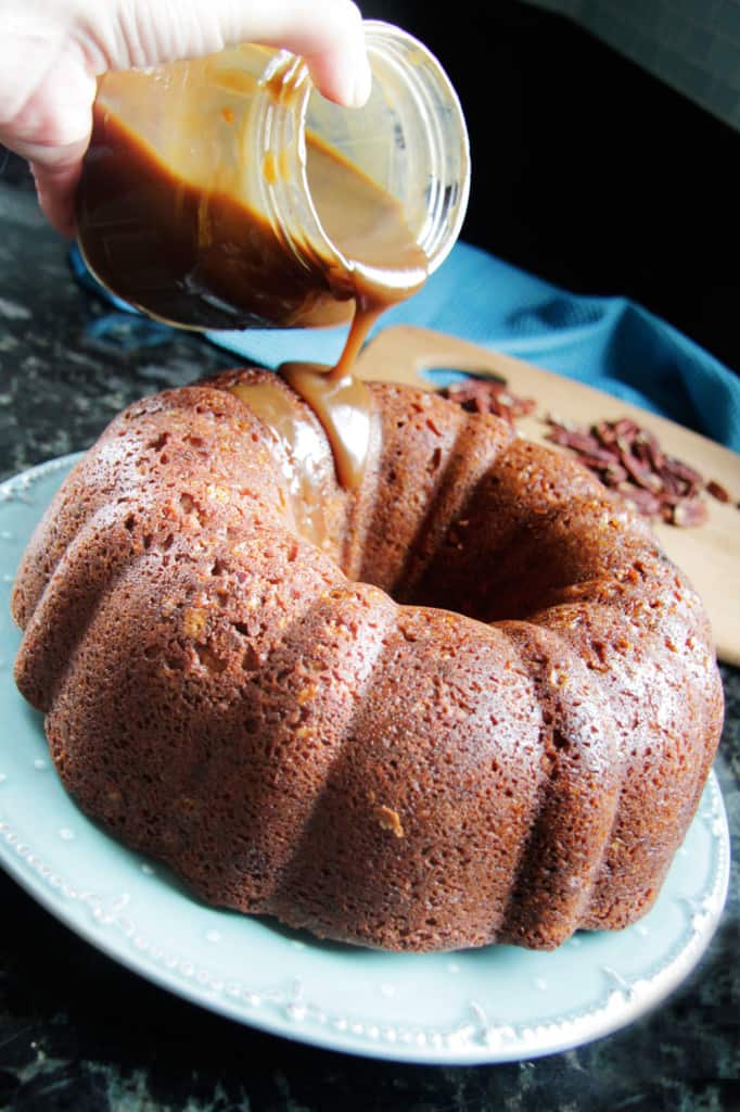 drizzling caramel sauce over a brown sugar pound