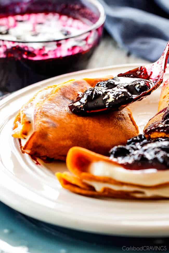 Adding Carrot Cake Crepes with Cream Cheese Filling and Blueberry Sauce on top.