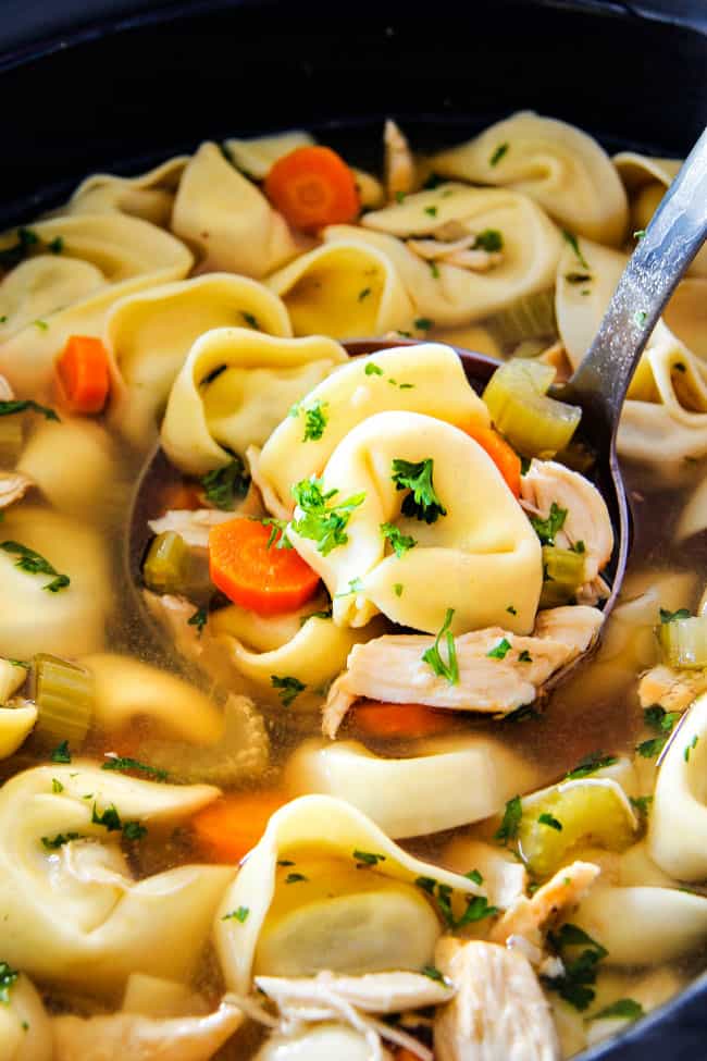 showing how to make Chicken tortellini soup by placing chicken in crockpot