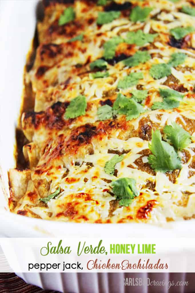 salsa verde chicken enchiladas in a white casserole dish with cilantro