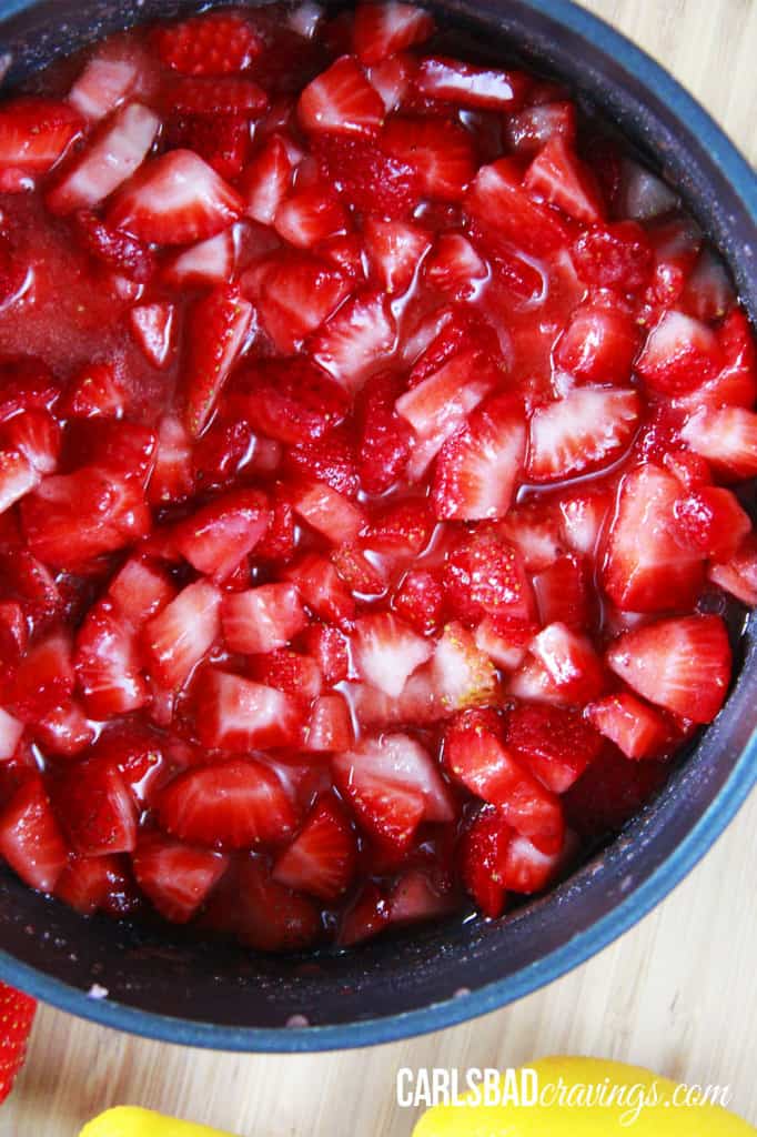 Home made Strawberry Syrup being cooked into a jam in a pot.
