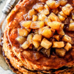 up close view of chunky cinnamon apple syrup on top of a stack of sweet potato pancakes