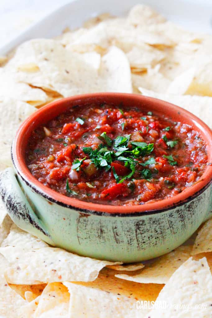 side view of a homemade salsa recipes surrounded by chips