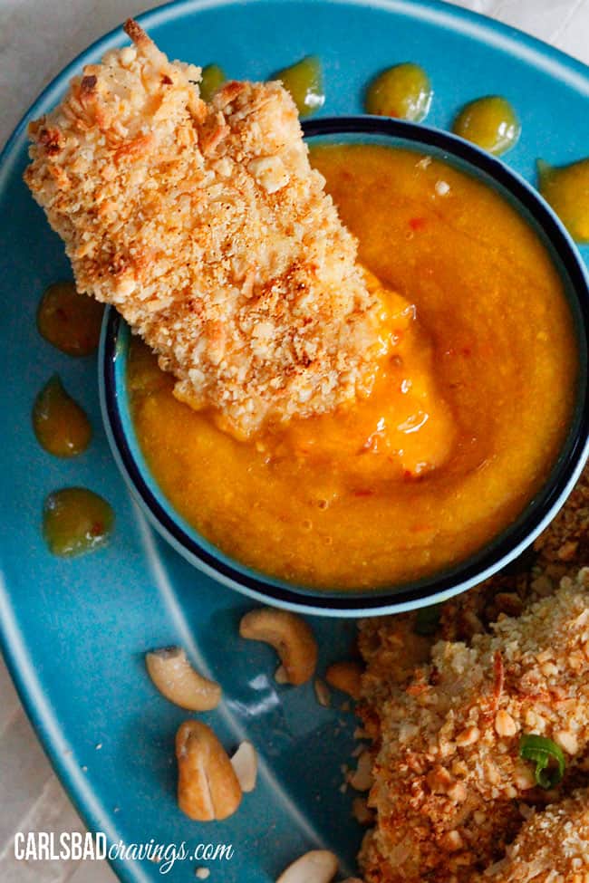  Coconut Crusted Chicken breasts sitting in dip