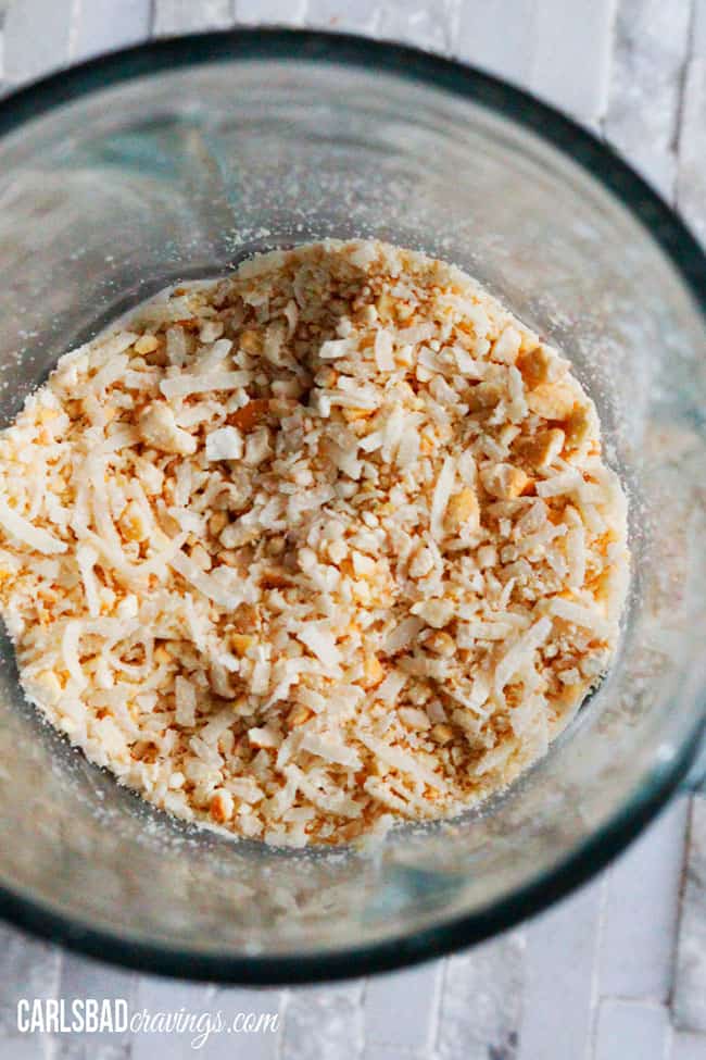 showing how to make  Coconut Crusted Chicken by pulsing coconut in the food processor