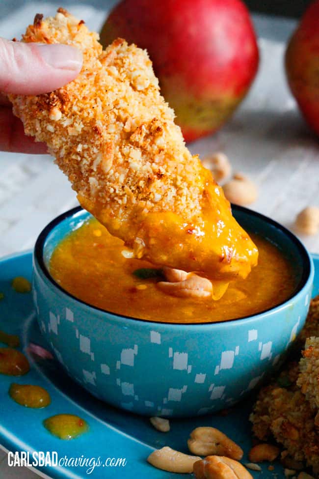 dipping Coconut Crusted Chicken into mango dip