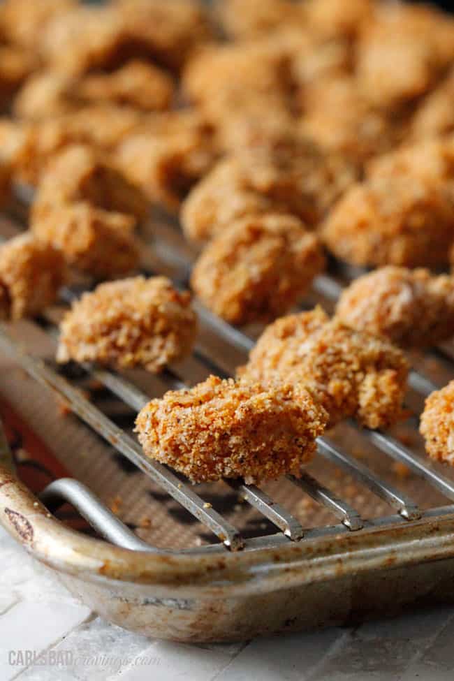 showing how to make popcorn chicken by baking it on a baking rack in the oven
