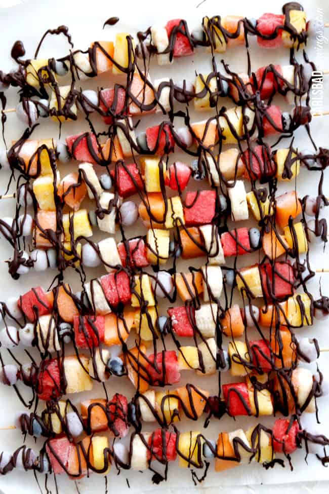 top view of fancy fruit skewers drizzled with chocolate
