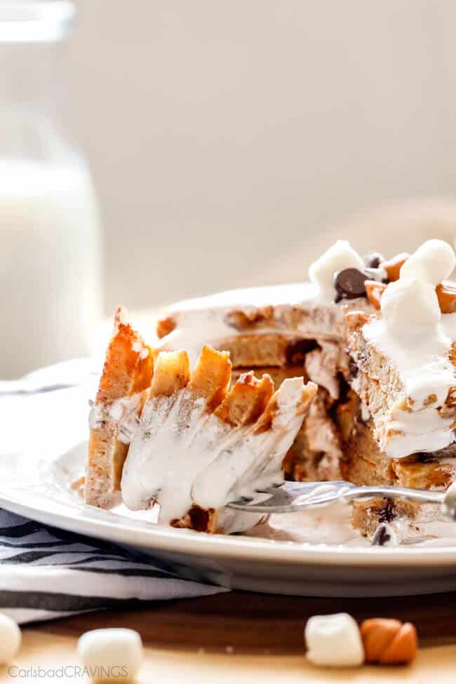 Fluffy S'mores Pancakes with a fork taking a large bite.