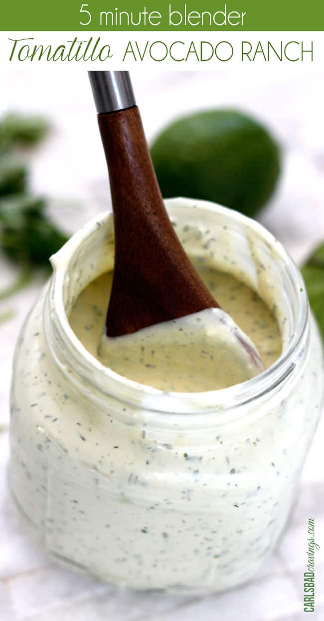  avocado dressing with a wood spoon in a glass jar