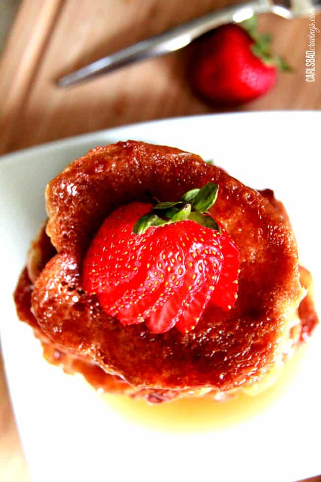 A top view of tall stack of Creme Brulee French Toast with red strawberries on top.