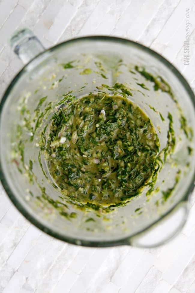 showing how to make chimichurri by  pulsing until it is soupy consistency