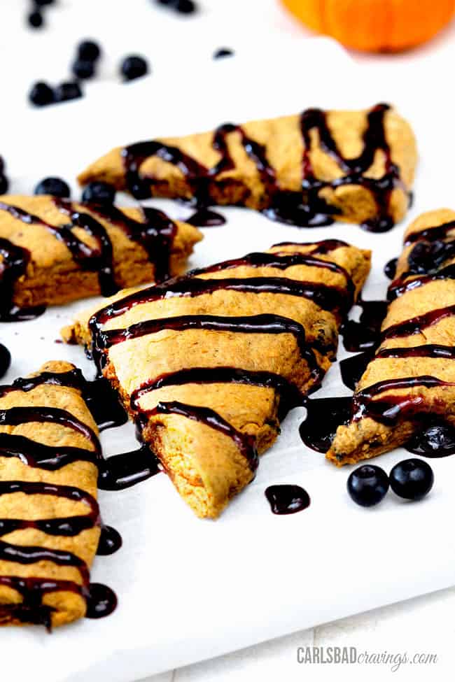 Pumpkin Scones with a cinnamon blueberry glaze on a white background.