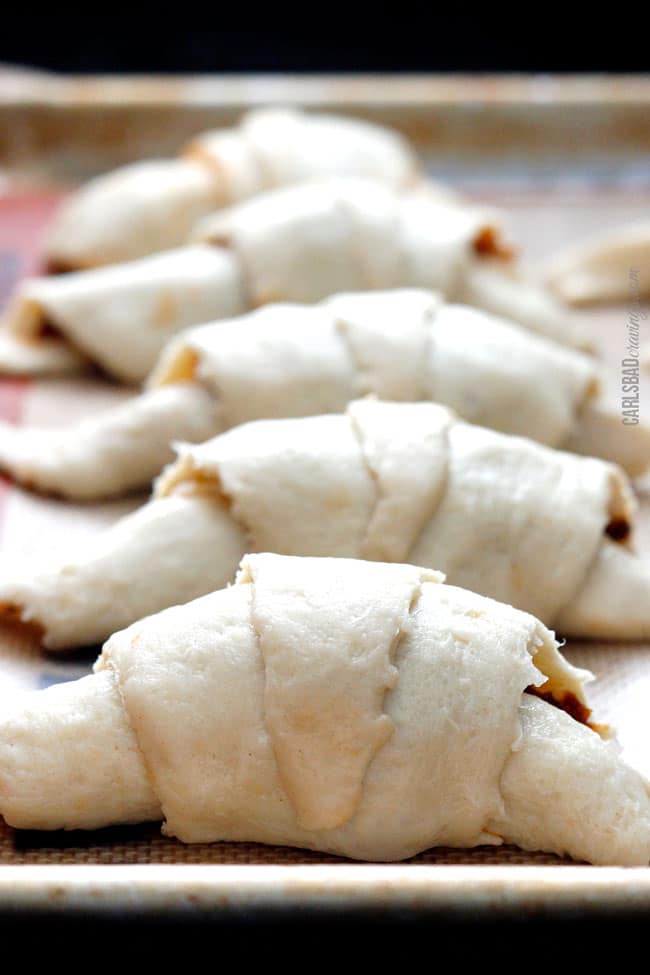 showing how to make crescent roll recipe by rolling up Pillsbury crescent rolls