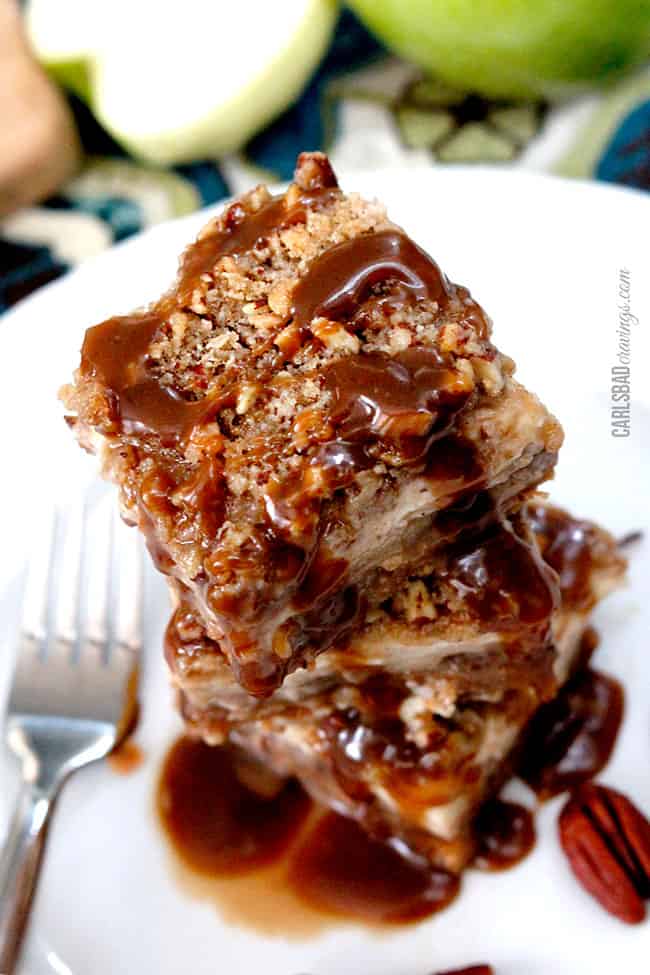 a stack of best Caramel Apple Cheesecake Bars on a white serving plate with a fork. 