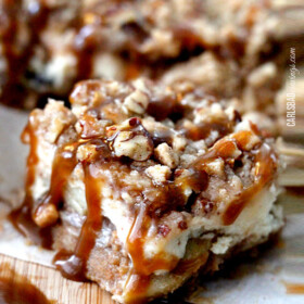 Candy Apple Cheesecake Bars on a wooden board.