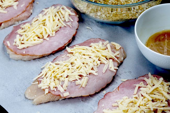 showing how to make chicken cordon bleu by pounding chicken thin and lining with ham and cheese