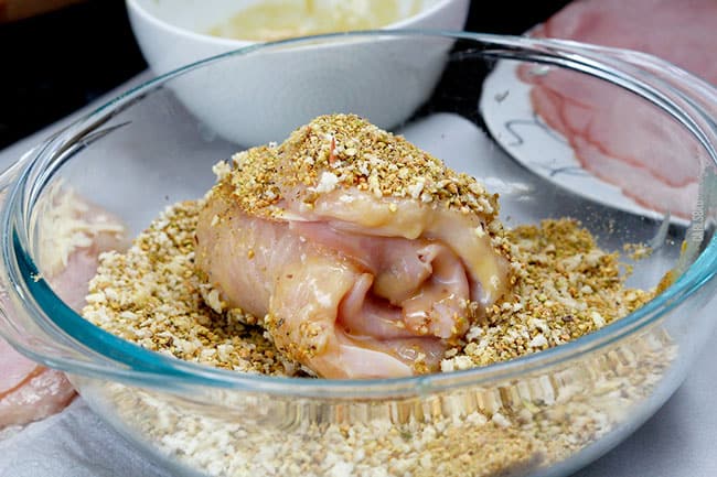 showing how to make best chicken cordon bleu by dreading chicken in breadcrumbs