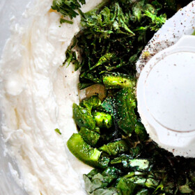 showing how to make whipped feta dip by mixing ingredients until smooth