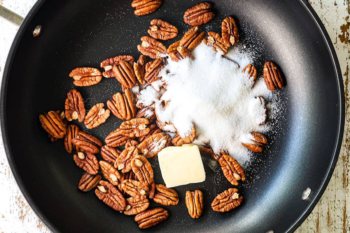 Showing how to make candied Nuts  (caramelize nuts) by combining pecans, butter and sugar in a nonstick pan