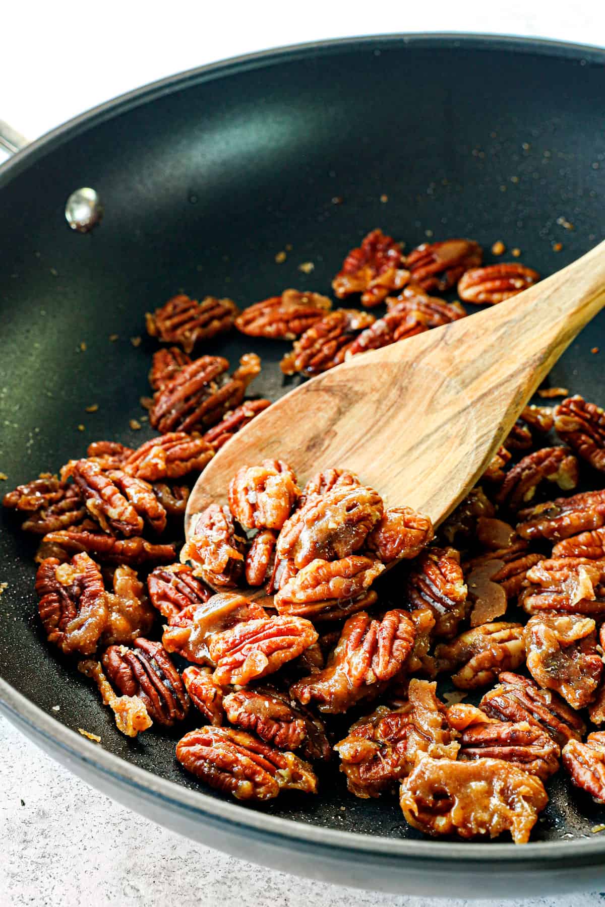 caramelized nuts for salads in a nonstick pan coating in butter and sugar