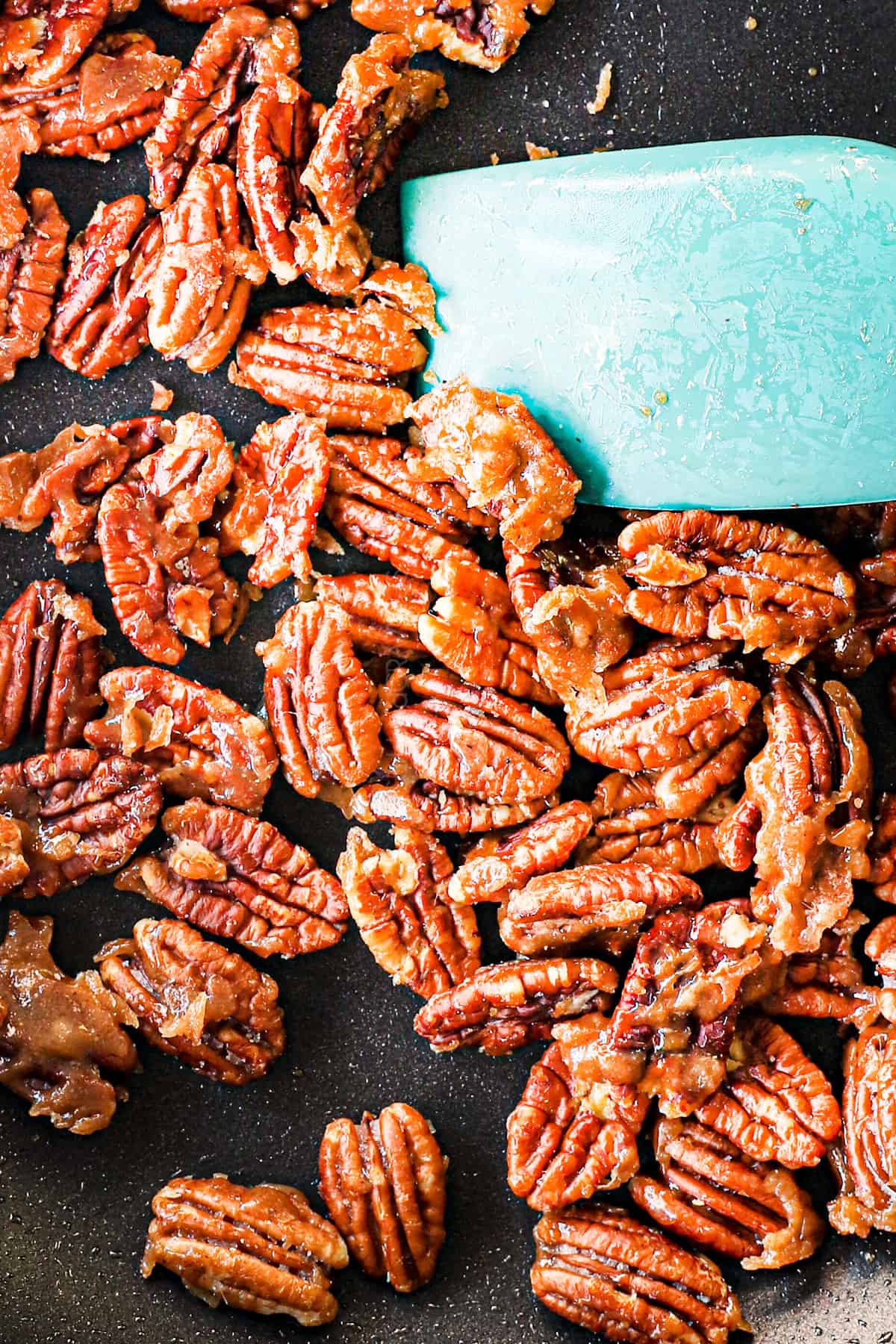 up close of making caramelized nuts (candied nuts) showing the sugar coating