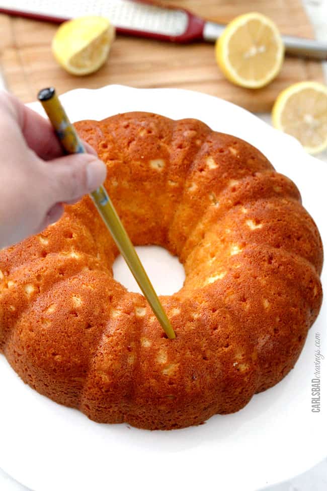 showing how to make lemon cake recipe by poking holes into Lemon Poke Cake.