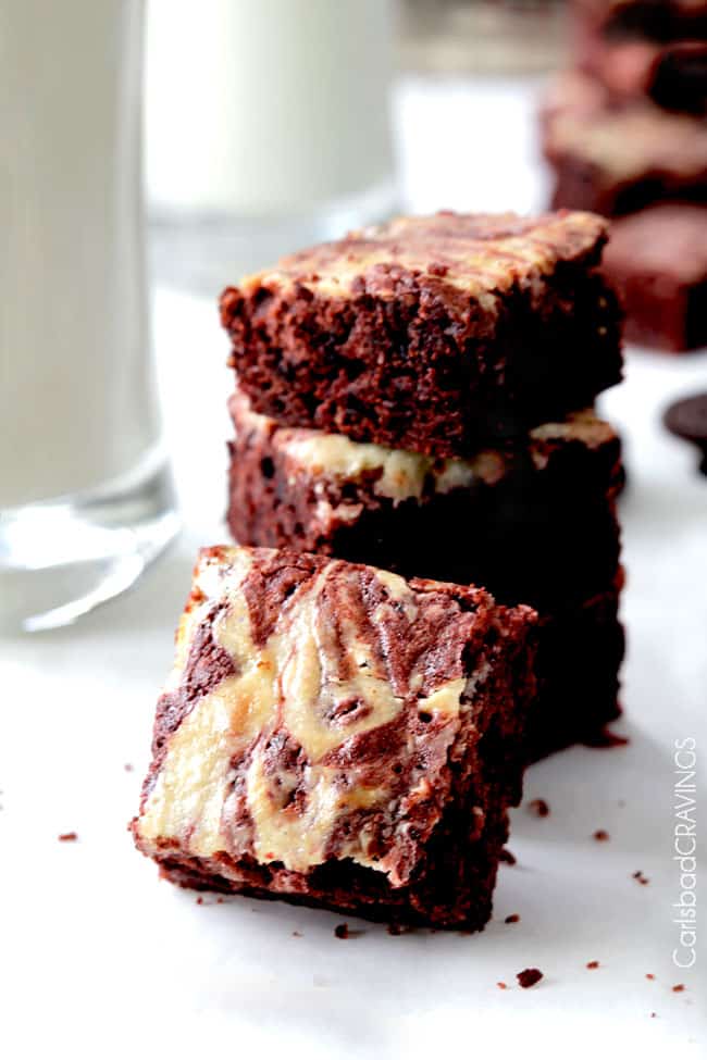 Red Velvet Oreo Brownies stacked next to milk front view.