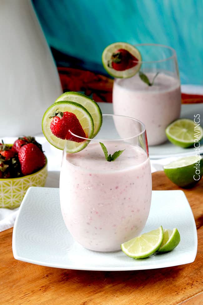 two high protein smoothies in glasses on white plates 