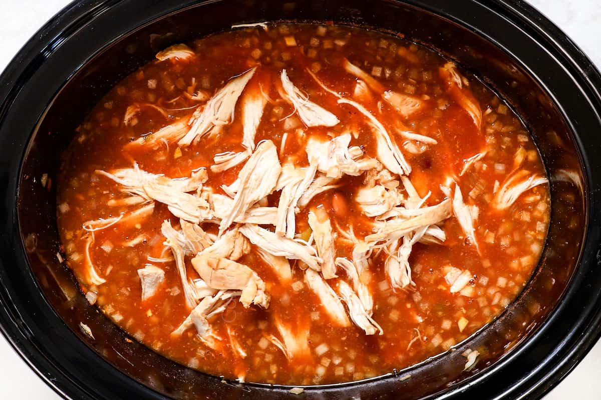 showing how to make chicken chili by shredding chicken and adding back to crockpot