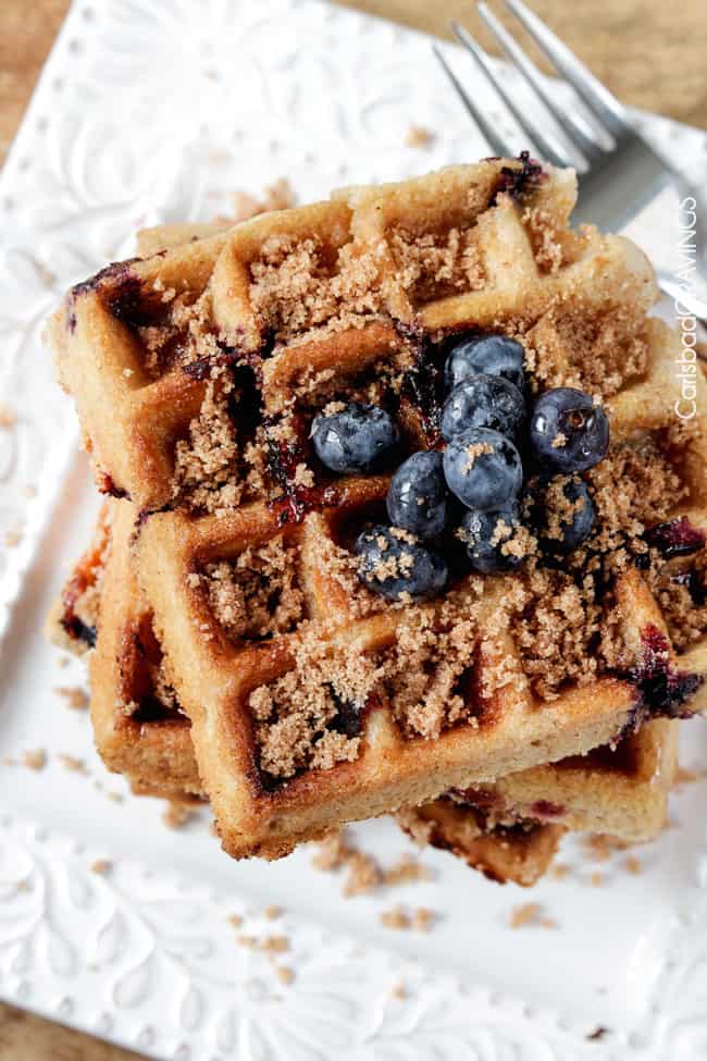Top view of Blueberry Waffles with blue berries and brown sugar on top.