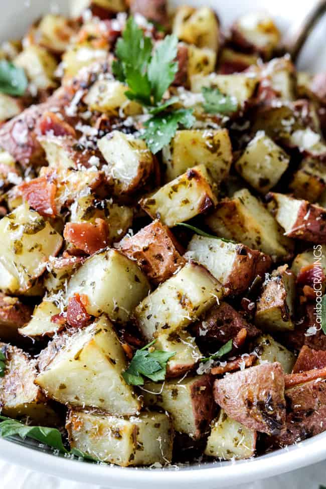Close up view of Roasted Potatoes with Bacon and Parmesan  with a serving spoon.