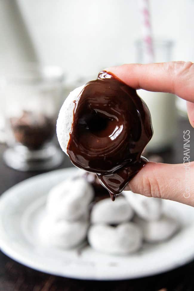 Chocolate Sauce with a white powder doughnut dipped in.