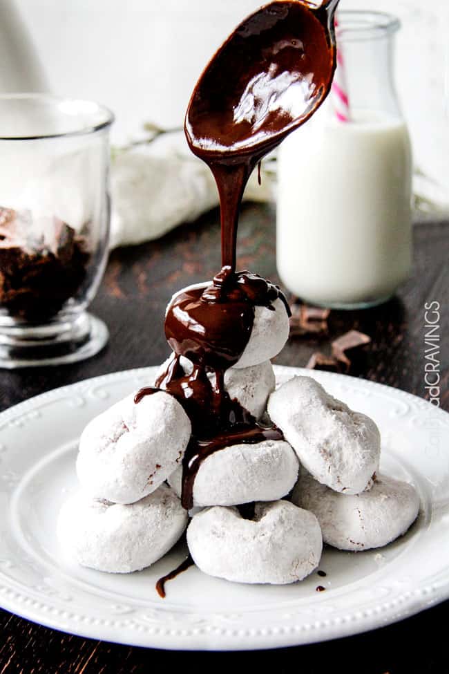 Showing how to make Chocolate Sauce by putting melting chocolate over top white powdered doughnuts. 