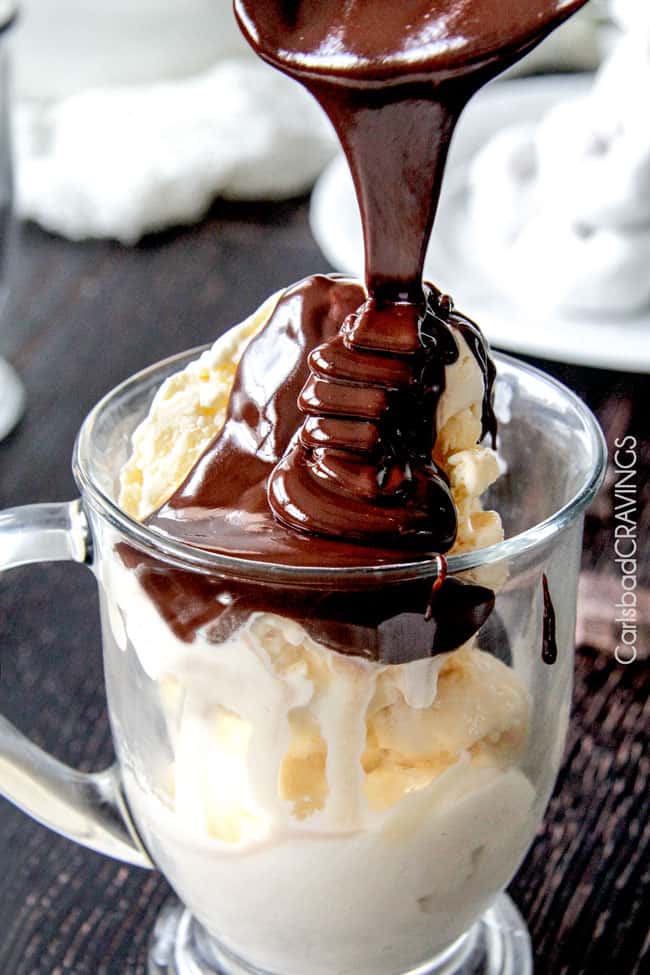 Home made Chocolate Sauce being poured over top vanilla ice cream. 