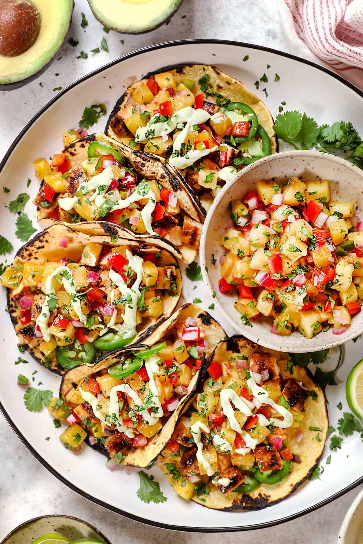 top view of serving lime chicken tacos on a platter with pineapple salsa