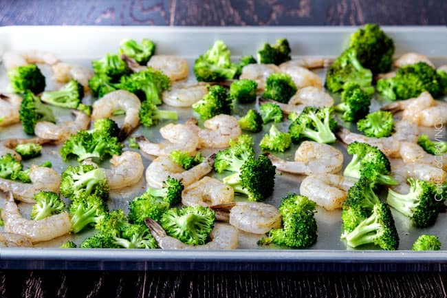 showing how to make Shrimp Fettuccine Alfredo with broccoli by adding shrimp and broccoli to a baking sheet