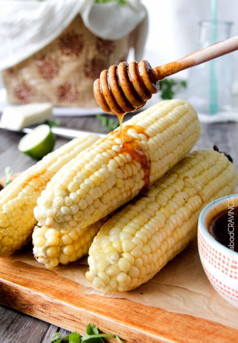 easy Roasted or grilled corn on the cob never tasted so delicious brushed with delectable Chipotle Honey Lime Butter sprinkled with cilantro and cotija cheese! Perfect for the 4th or roast year round. #corn #Mexicancorn #grilledcorn #chipotle