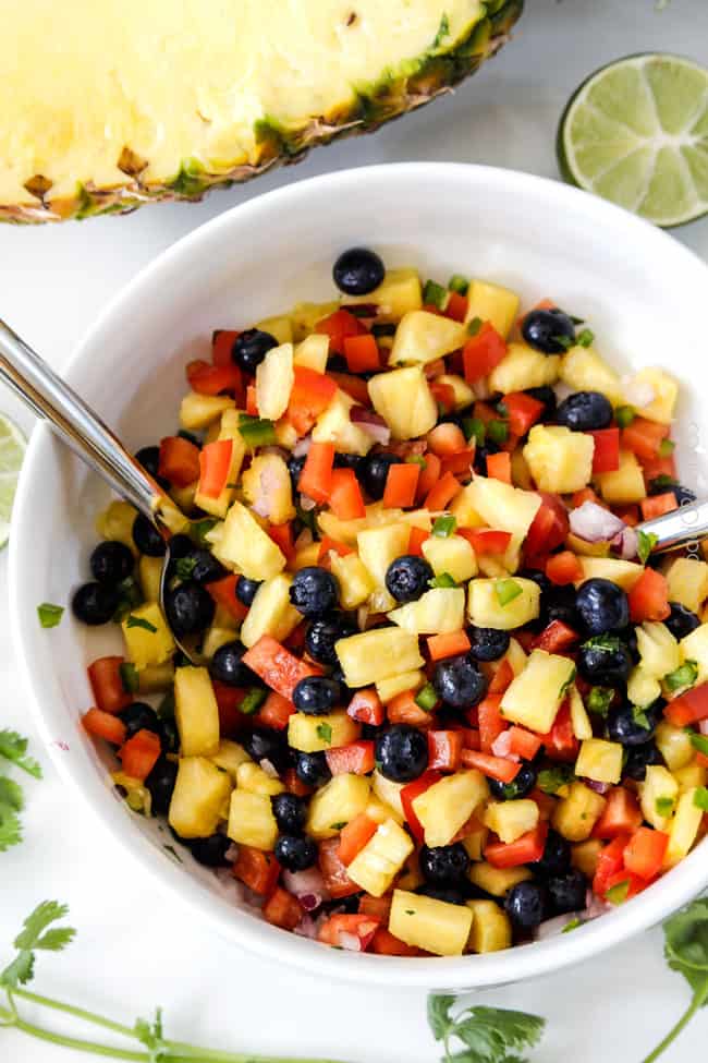 Close up of Blueberry Pineapple Salsa with half a pineapple on the size. 
