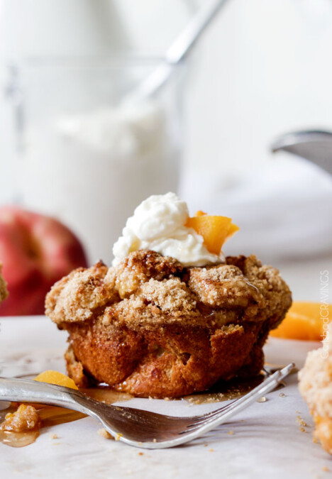 Baked Peaches and Cream French Toast Muffins are an irresistible STRESS FREE make-ahead breakfast bursting with sweet peaches, crowned with Cinnamon Streusel, doused with syrup and topped with luscious cream! !