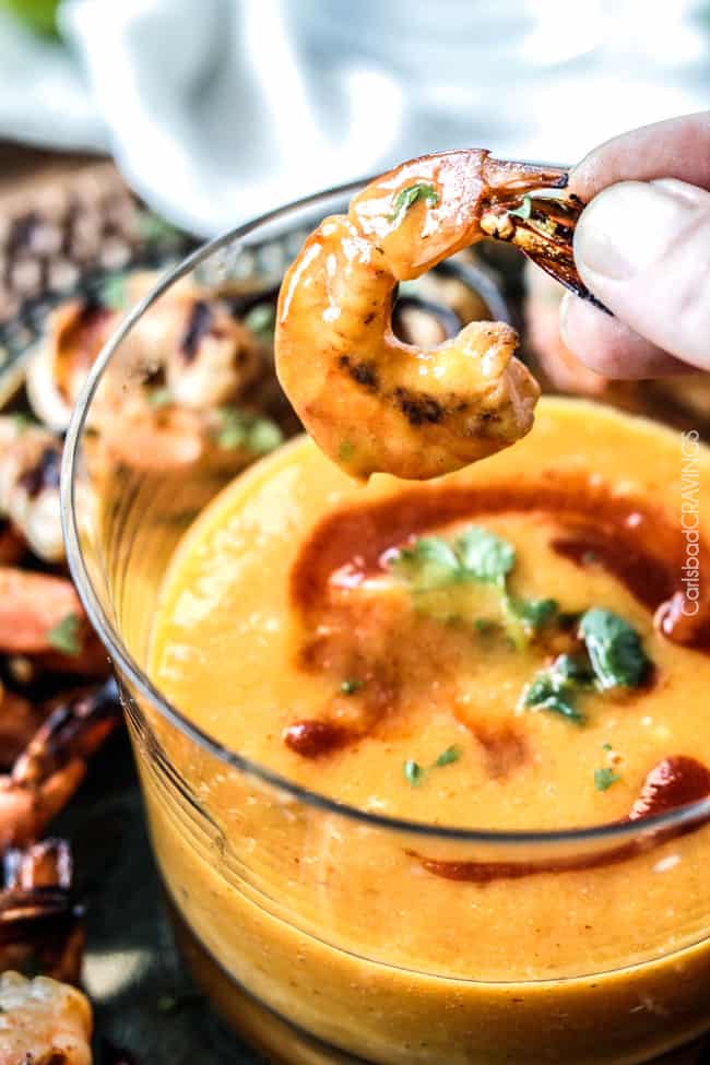 Holding Coconut Honey Lime Shrimp saturated in sauce after dipping.