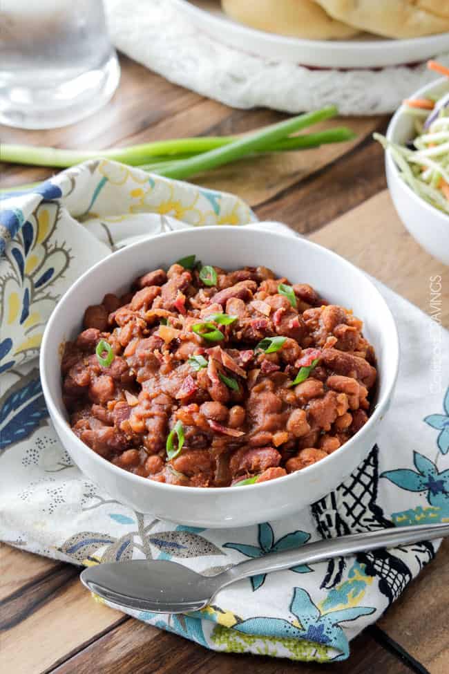 Hawaiian Barbecue Baked Beans in a white bowl with green union on top.